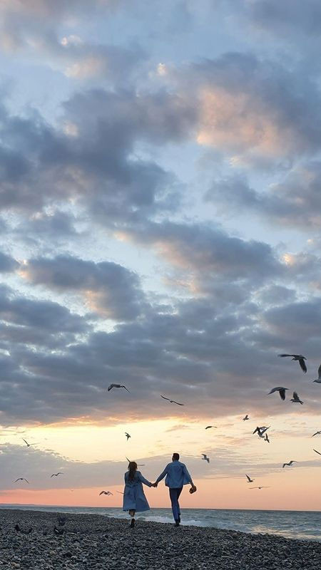 Ảnh nắm tay đôi lứa dưới ánh sáng vàng ấm áp của hoàng hôn