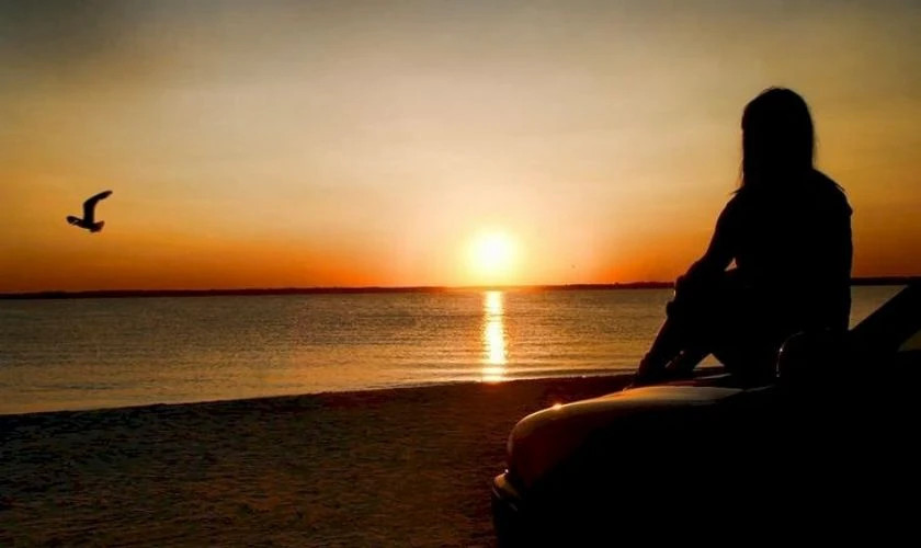 Bóng dáng một người cô đơn trước cảnh hoàng hôn rực rỡ trên biển