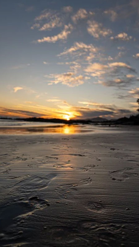 Cảnh mặt trời lặn xuống dưới đường chân trời biển, tạo dải màu tuyệt đẹp