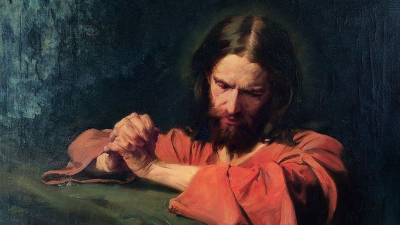Chúa Giêsu cầu nguyện với đôi tay chắp lại và ánh sáng bao quanh