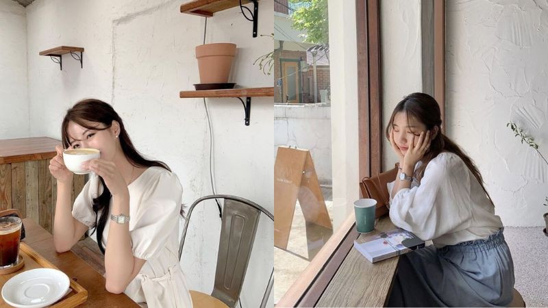 Cô gái dùng tách cà phê che một phần mặt khi chụp ảnh dáng đẹp che mặt tại quán cà phê