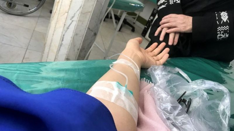 Hình ảnh bệnh nhân truyền nước có người thân bên cạnh chăm sóc