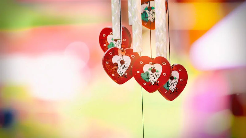 Hình ảnh chuông gió treo dưới mái hiên, tạo khung cảnh thơ mộng và bình yên