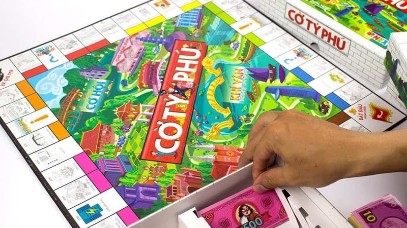 Hình ảnh mô phỏng sự giàu có với nhiều nhà và khách sạn trên bất động sản Monopoly