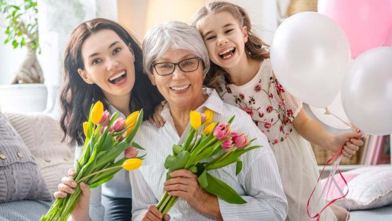 Hình ảnh người mẹ hạnh phúc nhận hoa, thể hiện niềm vui trong ngày đặc biệt.