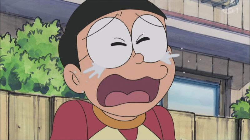 hình ảnh nobita buồn với cuốn sách