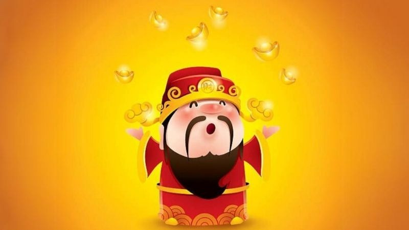 Hình nền Thần Tài tay cầm đĩnh vàng lớn với ánh sáng rực rỡ