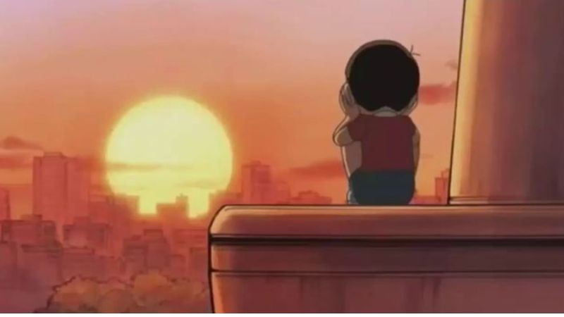 nobita buồn bã dựa vào tường